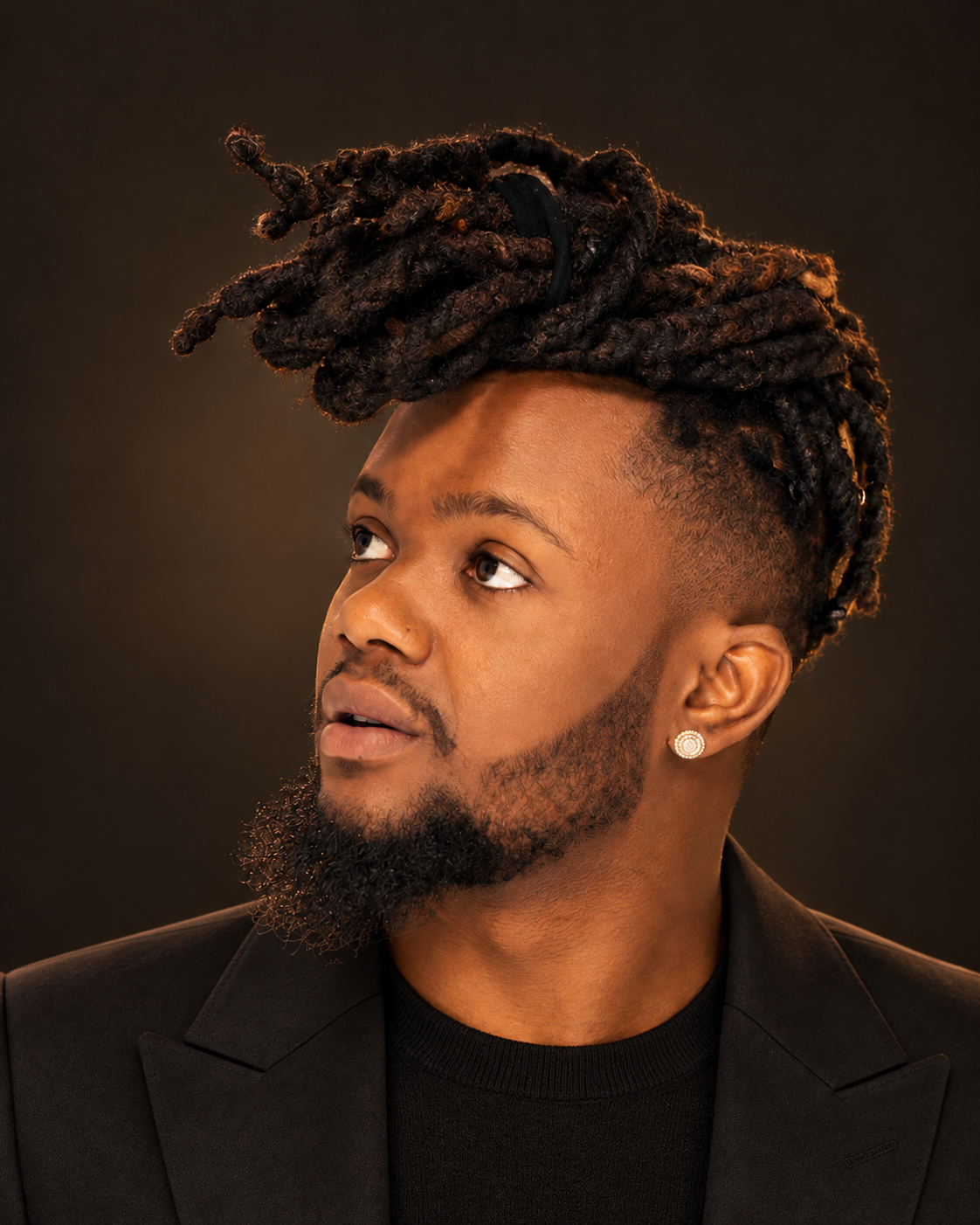 DPerfect in a tailored black jacket against a warm charcoal studio background